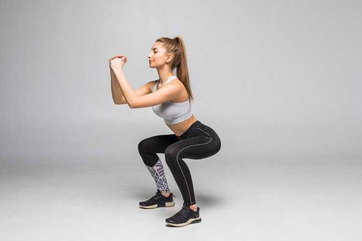 sporty-woman-doing-squats-muscular-fitness-woman-military-sportswear-isolated-white-wall-fitness-healthy-lifestyle-concept_231208-10499